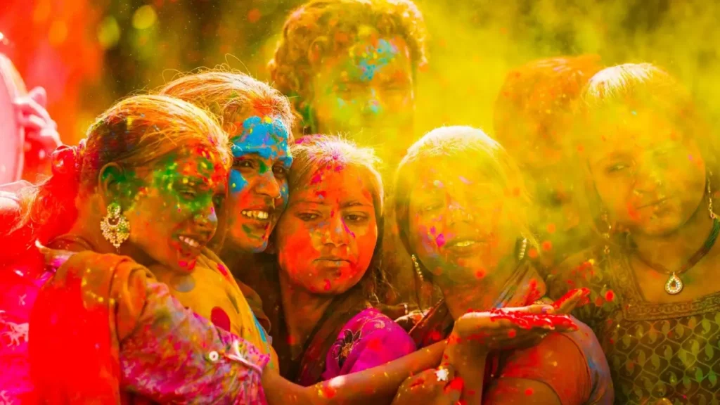 Cultures of India: Exploring the Soul of a Timeless Civilization 5 People celebrating Holi by throwing vibrant colored powders, showcasing India's Festival of Colors, joyful traditions, and cultural heritage.
