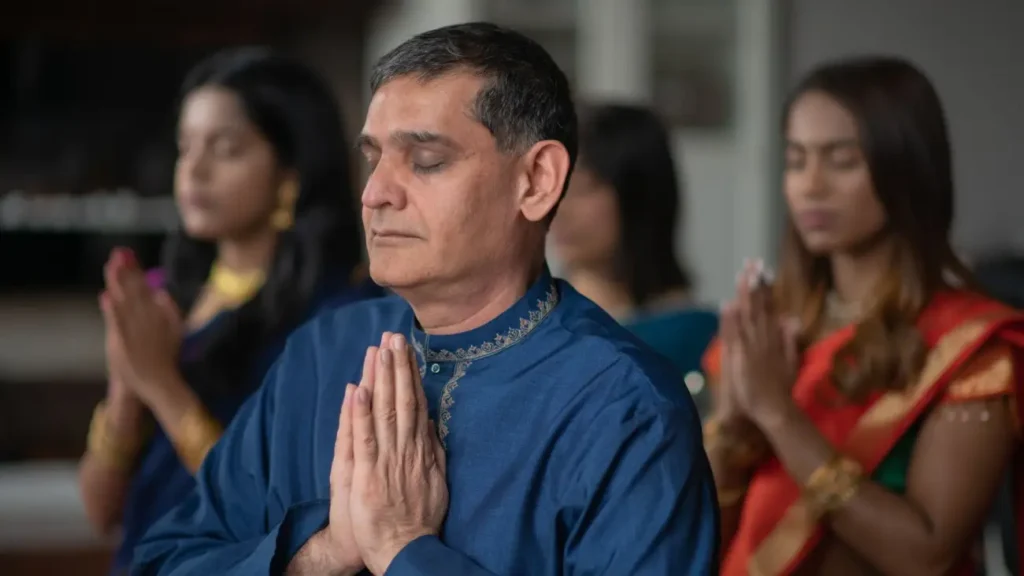 Cultures of India: Exploring the Soul of a Timeless Civilization 13 People dressed in traditional Indian attire offering prayers with folded hands, reflecting India's spirituality, religious traditions, and cultural harmony.