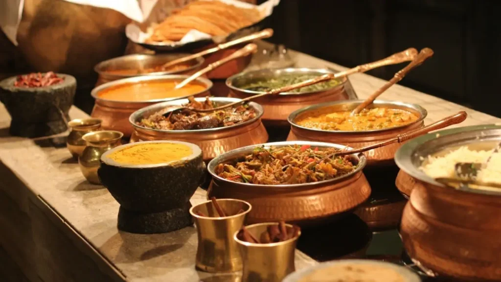 Cultures of India: Exploring the Soul of a Timeless Civilization 10 Traditional Indian dishes served in copper pots with rice, curries, vegetables, and spices, showcasing the rich flavors and culinary heritage of Indian cuisine.