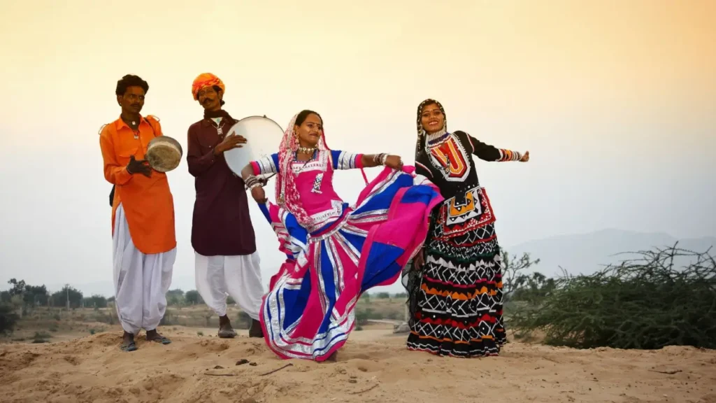 Cultures of India: Exploring the Soul of a Timeless Civilization 12 Indian folk dancers performing in colorful traditional attire with musicians playing drums, showcasing the vibrant music and dance traditions of India's cultural heritage.