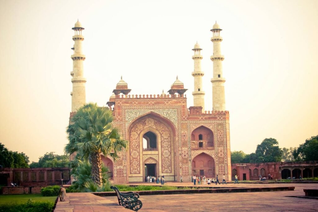 Grand entrance gateway with four marble minarets at Akbar's Tomb in Sikandra, Agra, Uttar Pradesh, India.