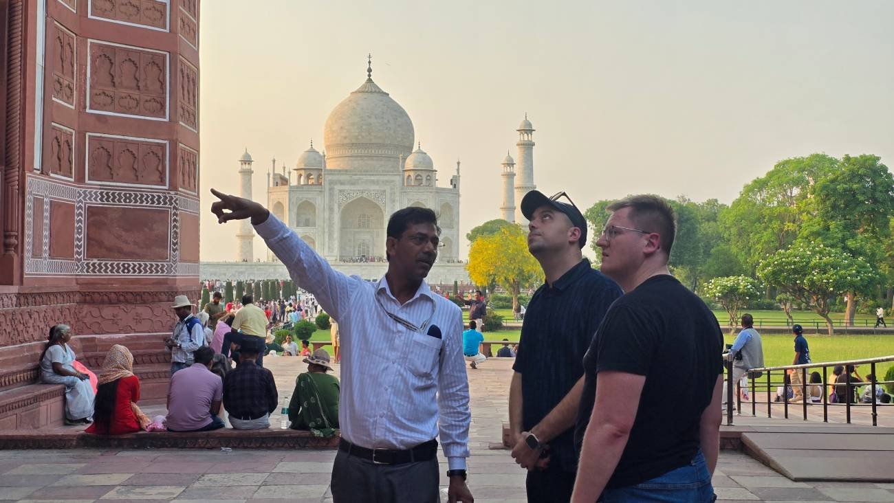 Safety and Comfort 1 Professional tour guide Anjum Saeed explaining the Taj Mahal to international tourists during a private sightseeing tour in Agra, India.